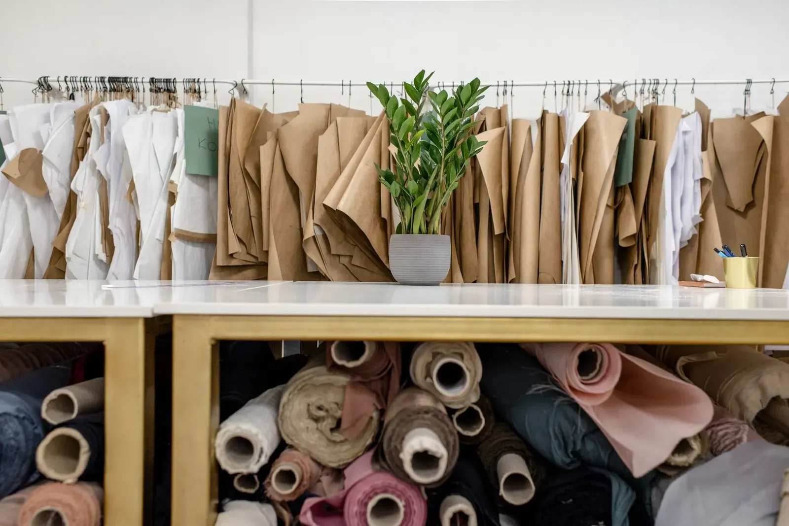 Fabric rolls and pattern pieces in the tailoring room at the Ring Road flagship
