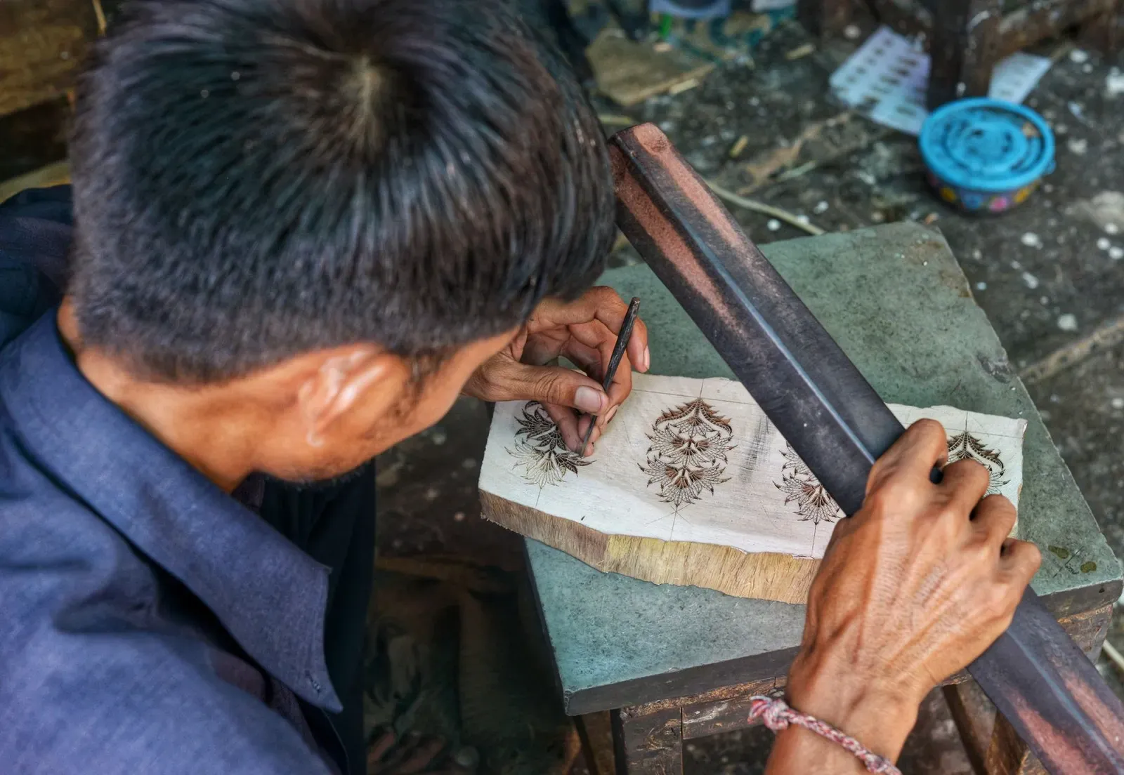 An artisan carving a wooden printing block